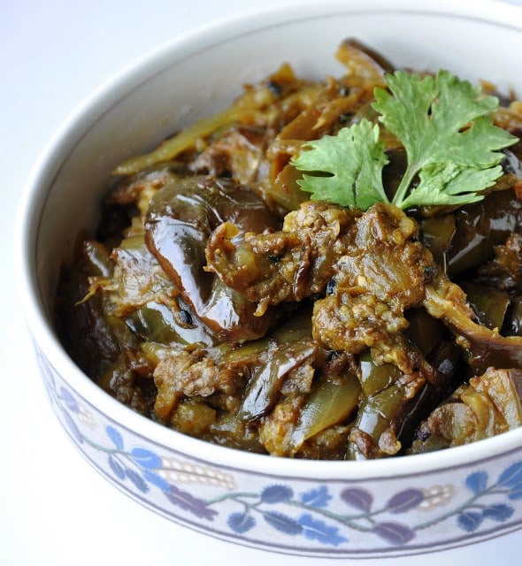 A bowl of cooked eggplant garnished with cilantro.