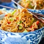 Hakka Noodles in a blue & white bowl with chopsticks.