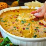 Pav Bhaji Dip with a chip scooping up the dip.