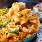 Baked Salsa Mac and Cheese with a large spoon scooping some up.