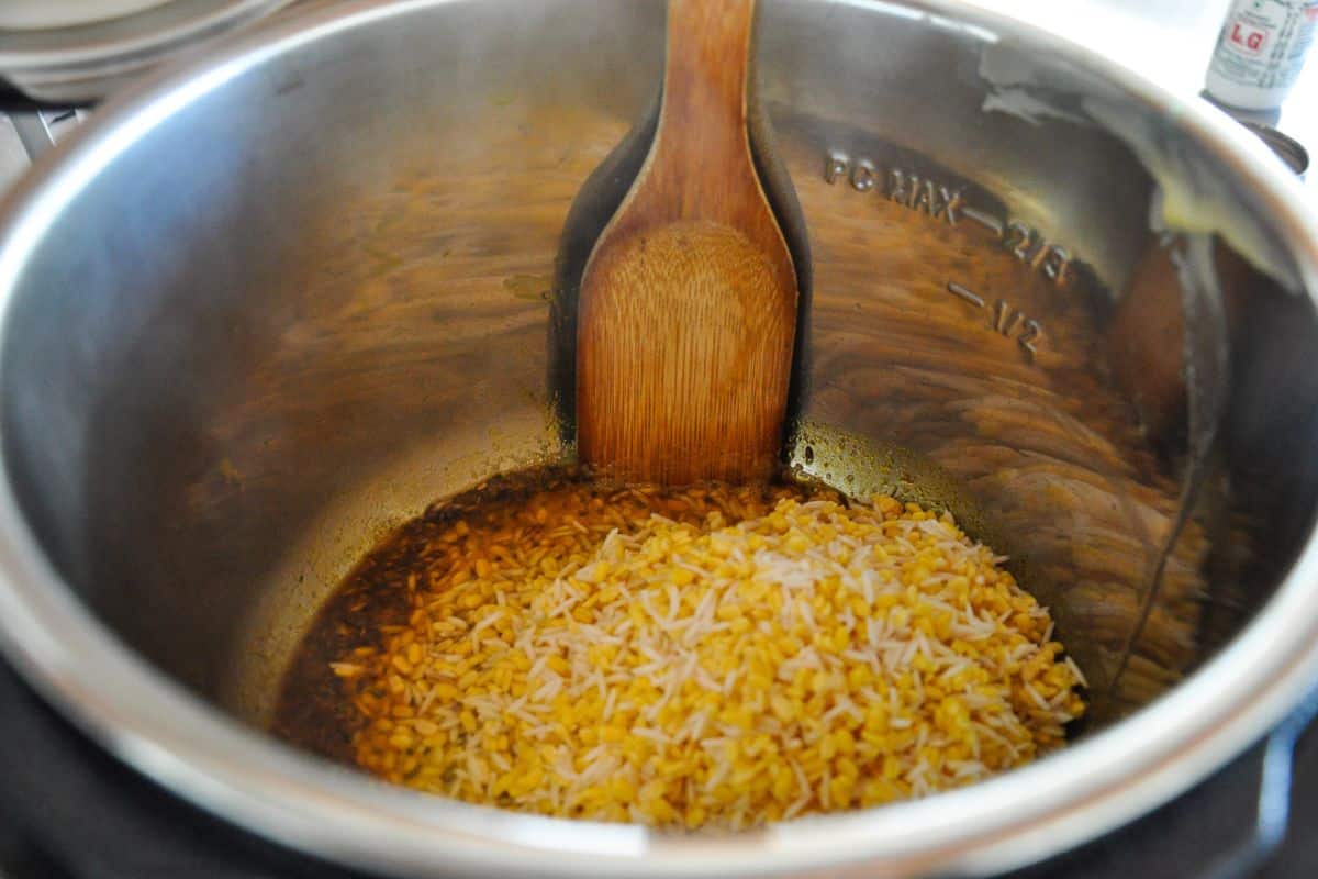 Add rice and lentils to the sauteed spices.