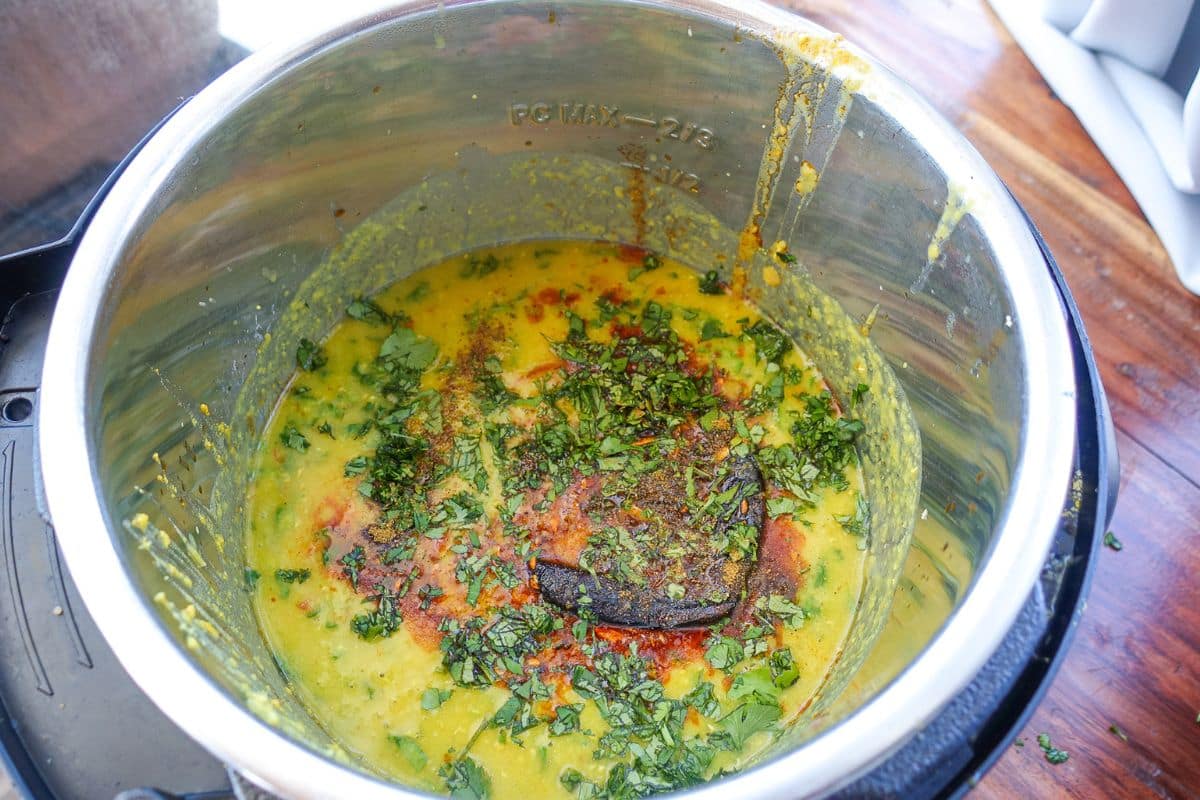 Masoor Dal garnished with tadka, fresh cilantro, and garam masala.