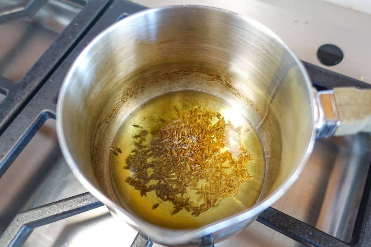 Tadka for Masoor Dal - added oil, asafoetida, and cumin seeds.