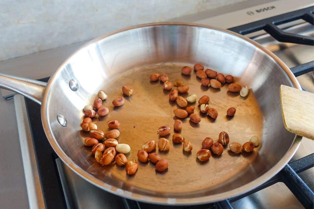 Dry roasting peanuts in a pan for Quinoa Bhel Salad.