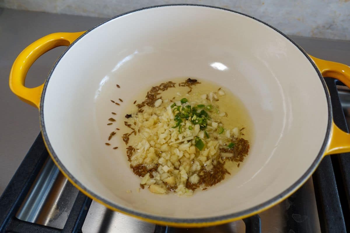 Add ginger, garlic, and green chilies.