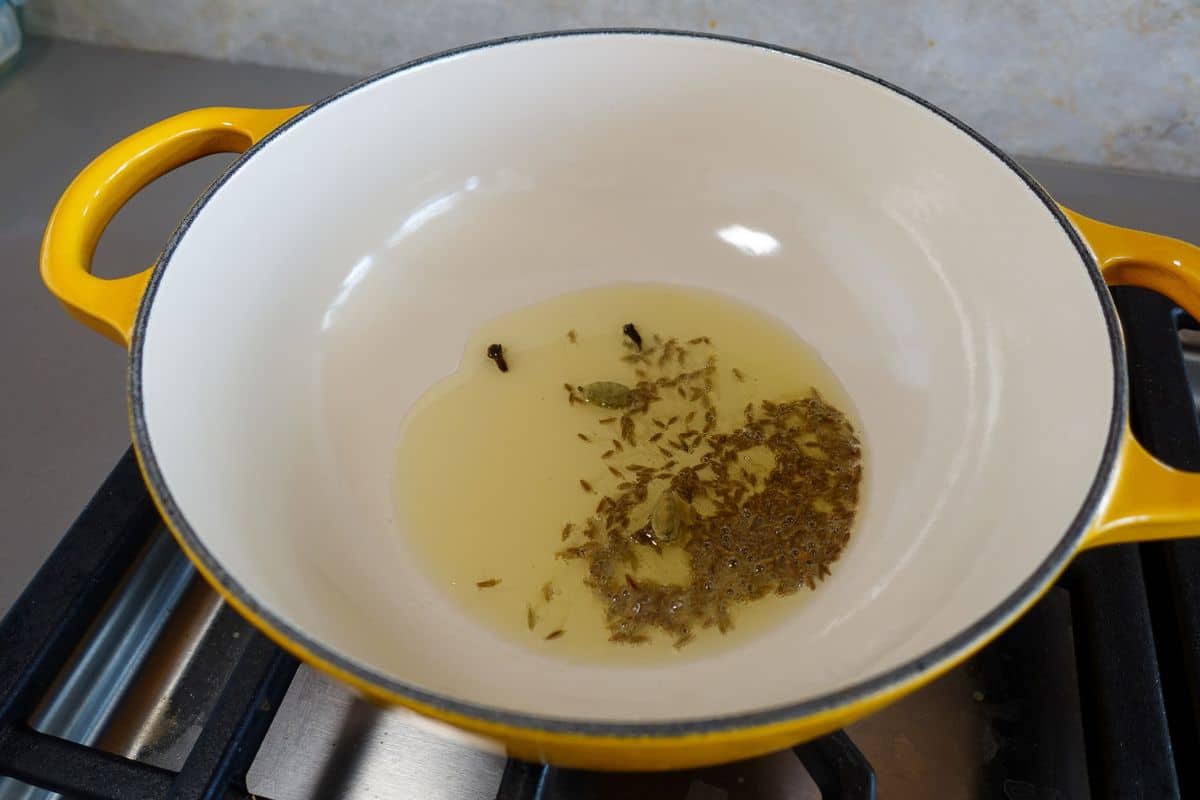 Add oil along with whole spices.