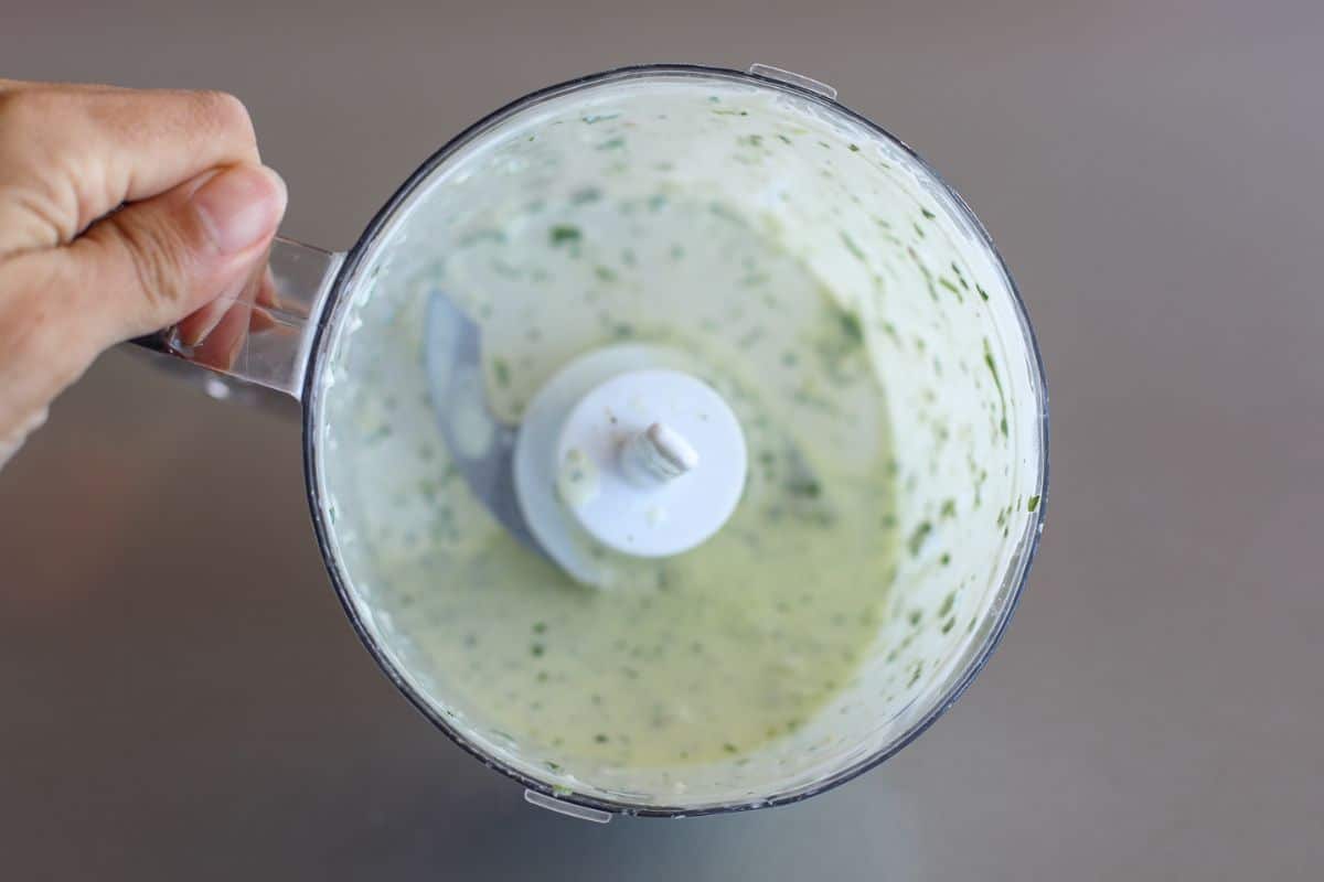 Cilantro Mint Garlic Sauce is ready sitting in a food processor.