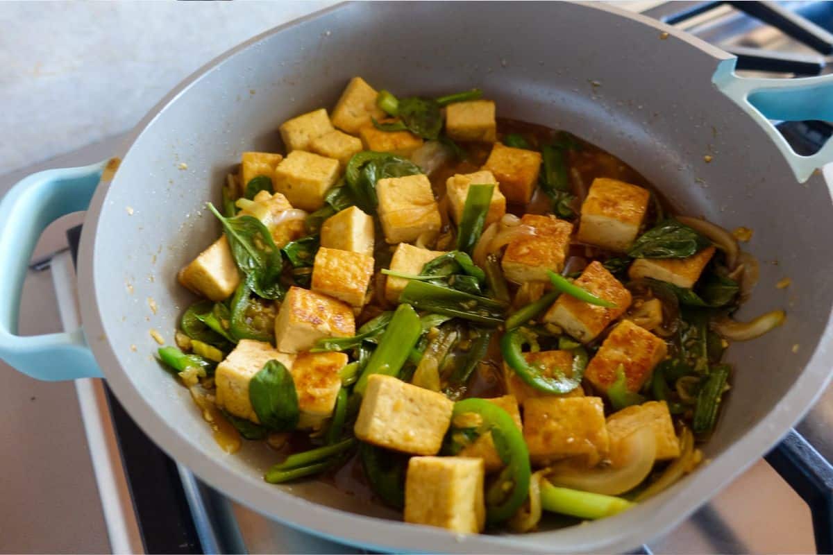 Thai Basil Tofu with Garlic and Jalapeno is ready sitting in a ceramic nonstick.