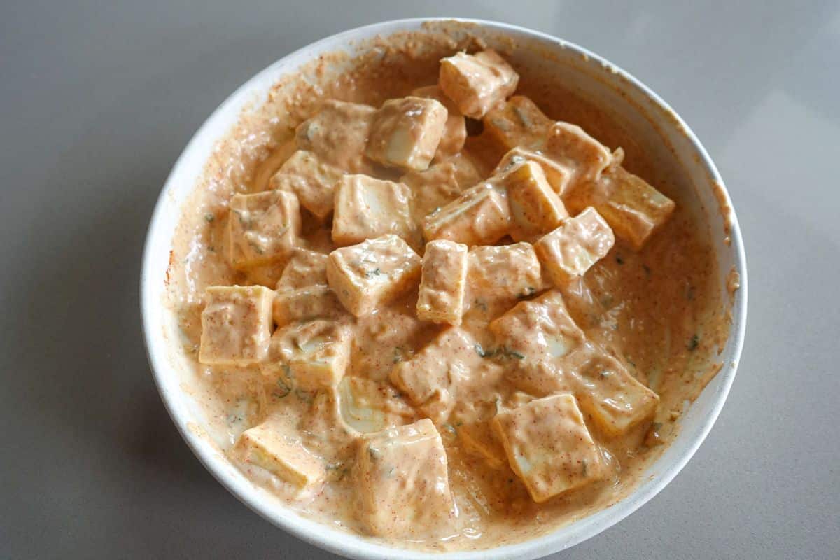 For paneer tikka sliders, add cubed paneer to the tandoori marinade and mix.