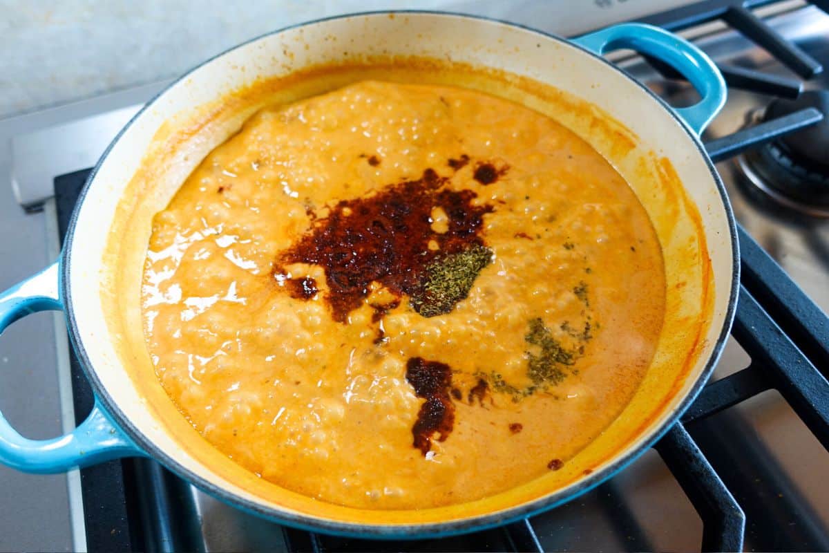 Add Indian and Italian spices to a coconut milk sauce in an enameled braiser to make marry me paneer.