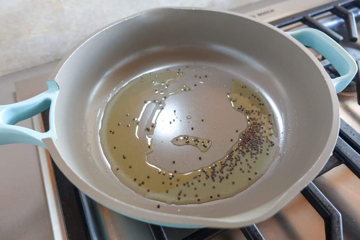 In a pan there is oil and mustard seeds.