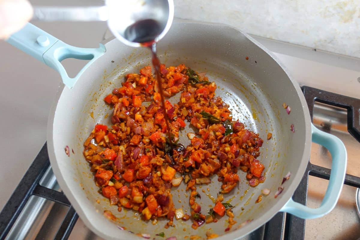 Add soy sauce to a nonstick pan for Egg Bhurji.